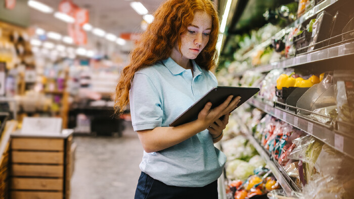 © Jacob Lund, stock.adobe.com Junge Verkäuferin im Supermarkt